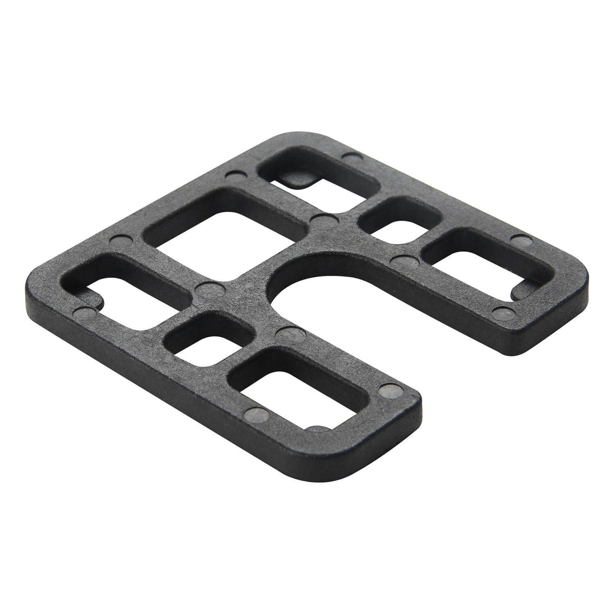 A black heavy-duty moulded load bearing shim with multiple rectangular and curved cutouts, shown on a plain white background.