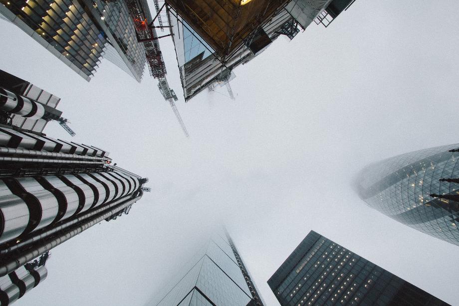 low angle photo of high rise building covered with fog